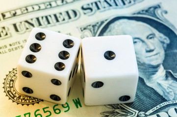 Close up of white dice and dollar cash money