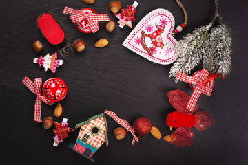Christmas or new year frame with xmas decorations and nuts on black stone background