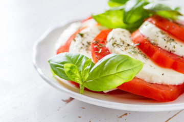 Caprese salad on white plate, closeup