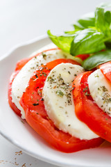 Caprese salad on white plate, closeup