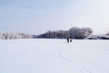 Fototapeta na wymiar winter fishermen on frozen lake