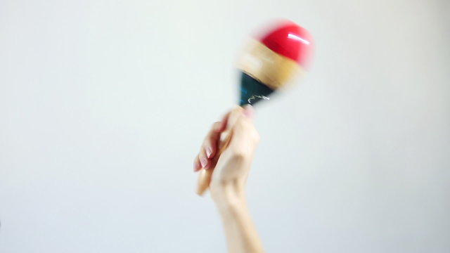 Hands playing marakas (Shakers), white background