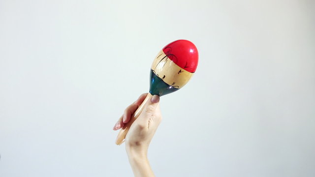 Hands playing marakas (Shakers), white background