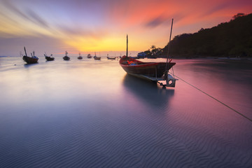 Fishing boats seaside  beach during sunset .