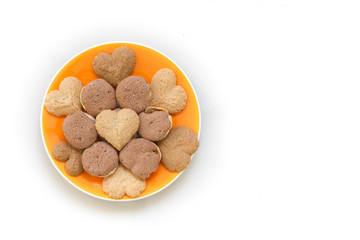 Chocolate cookies and butter cookies on orange dish on white background