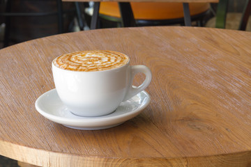 A cup of Coffee, latte on the wooden table