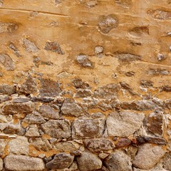 Old Stone Wall Made From Granite Rocks And Ripped Plaster