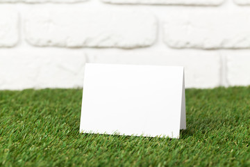 Blank business cards on grass