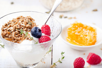 Healthy breakfast. Granola with pumpkin seeds, honey, yogurt, fresh berries .