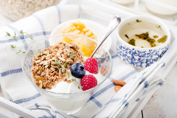 Healthy breakfast. Granola with pumpkin seeds, honey, yogurt, fresh berries .