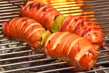 Fatty Sausages On The Hot Barbecue Flaming Charcoal Grill