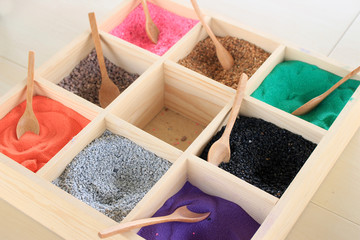 Colourful sands in wood box