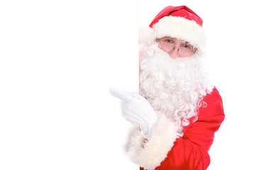 Kind Santa Claus pointing in white blank sign, isolated on white background