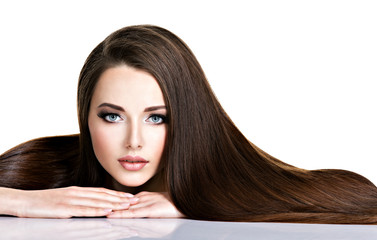 Portrait of beautiful young woman with long straight brown hair