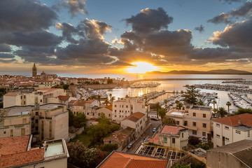 Sunset over city of Alghero on west coast of Sardinia - obrazy, fototapety, plakaty