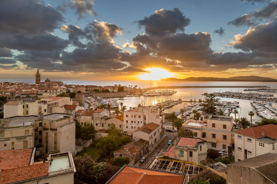 Sunset over city of Alghero on west coast of Sardinia