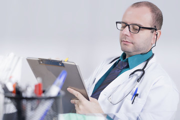 Doctor writing down in an office 