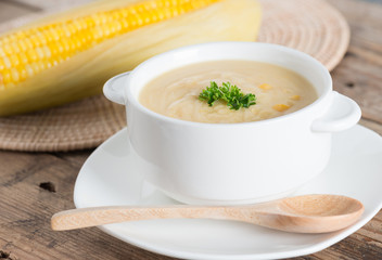Fresh corn soup in white bowl.