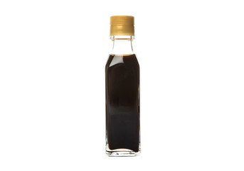 Balsamic vinegar in a glass bottle over white background