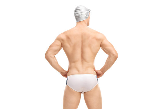 Muscular male swimmer in white swim trunks