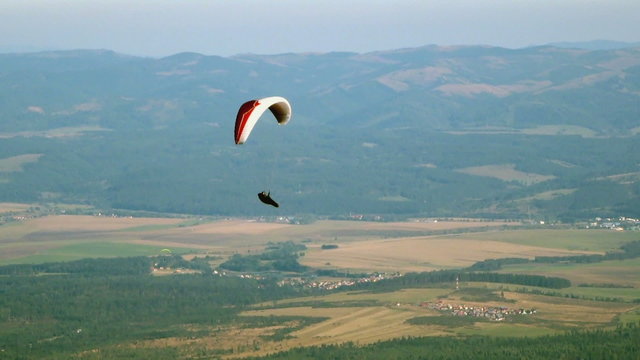 Colorful hang glider in sky over valley, Slovakia