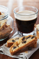 Coffee with biscotti or cantucci on wooden vintage table, traditional Italian biscuit or cookie
