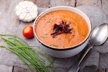 Tomato soup with sun dried tomatoes. Wooden background