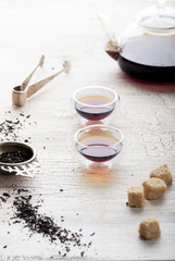Black tea in a transparent teapot and cups 