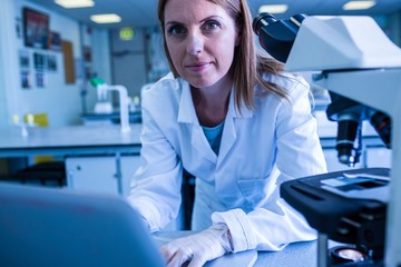 Scientist working with a laptop in laboratory