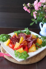 salad with tomatoes, orange and chorizo