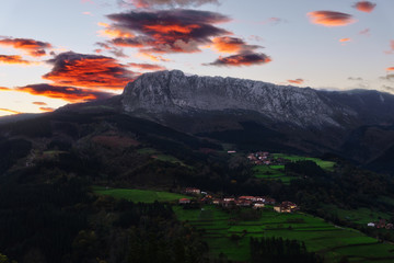 Fototapeta na wymiar Itxina mountain with Zaloa and Urigoiti villages at sunrise