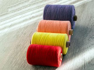 colored spools of thread for seamstresses, side view
