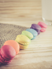 French macaroons on sack with wood background on filter color