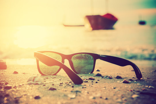 Fototapeta black sunglasses and sea background with blure boat
