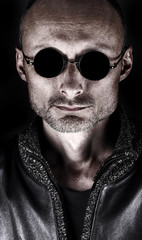 Stylized portrait of a middle-aged man in dark glasses