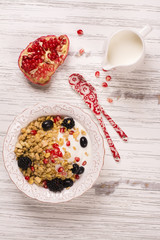 Crunchy granola with nuts, yogurt and fresh berries. Healthy breakfast concept. Top view