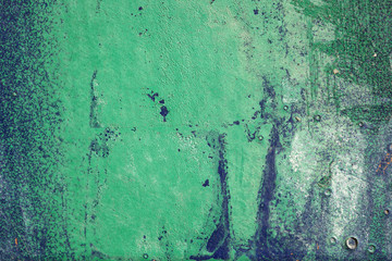 Hoarse,scratched and peeled surface with green and blue paint