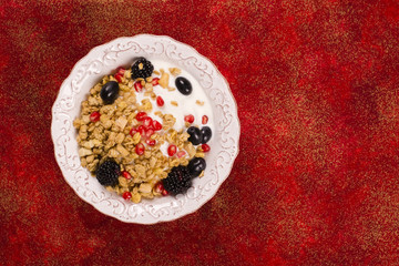 Crunchy granola with nuts, yogurt and fresh berries. Healthy breakfast concept. Top view