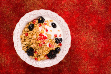 Crunchy granola with nuts, yogurt and fresh berries. Healthy breakfast concept. Top view