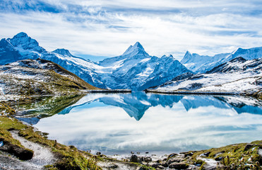 Swiss alps water reflection in Bachalpsee - mountain lake above Grindelwald, Switzerland.