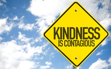 Kindness Is Contagious sign with sky background