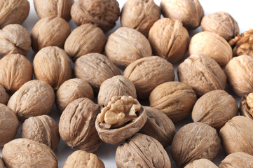 pile of walnuts in the foreground represent a healthy diet