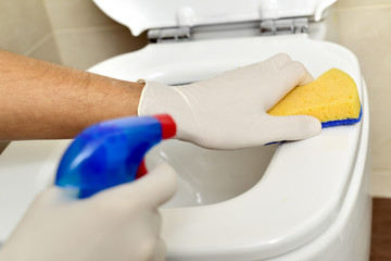 young man cleaning a toilet