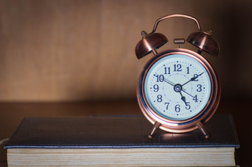 Alarm clock and book.