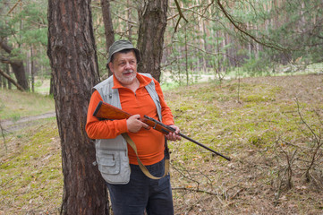 Positive portrait of senior ranger with rifle