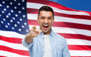 angry man pointing on you over american flag