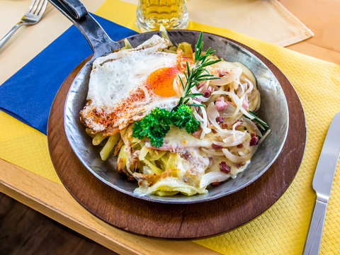 Famous Swiss Rosti with ham, cheese, eggs, onion and rozmarin.