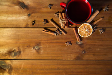 tea cup with winter spices on wooden table