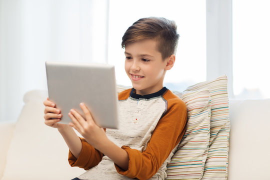 Smiling Boy With Tablet Computer At Home