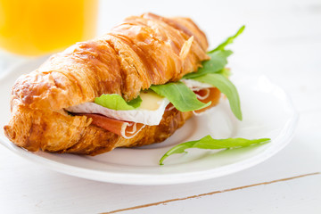 Sandwich croissant with ham brie arugula
